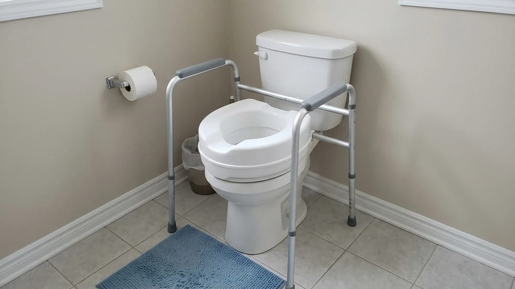 raised toilet seat with toilet safety frame showing extra support after hip surgery