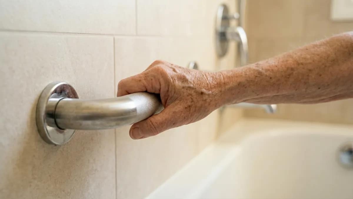 Best grab bars for arthritis and weak grip shown with a senior hand comfortably holding a textured grab bar