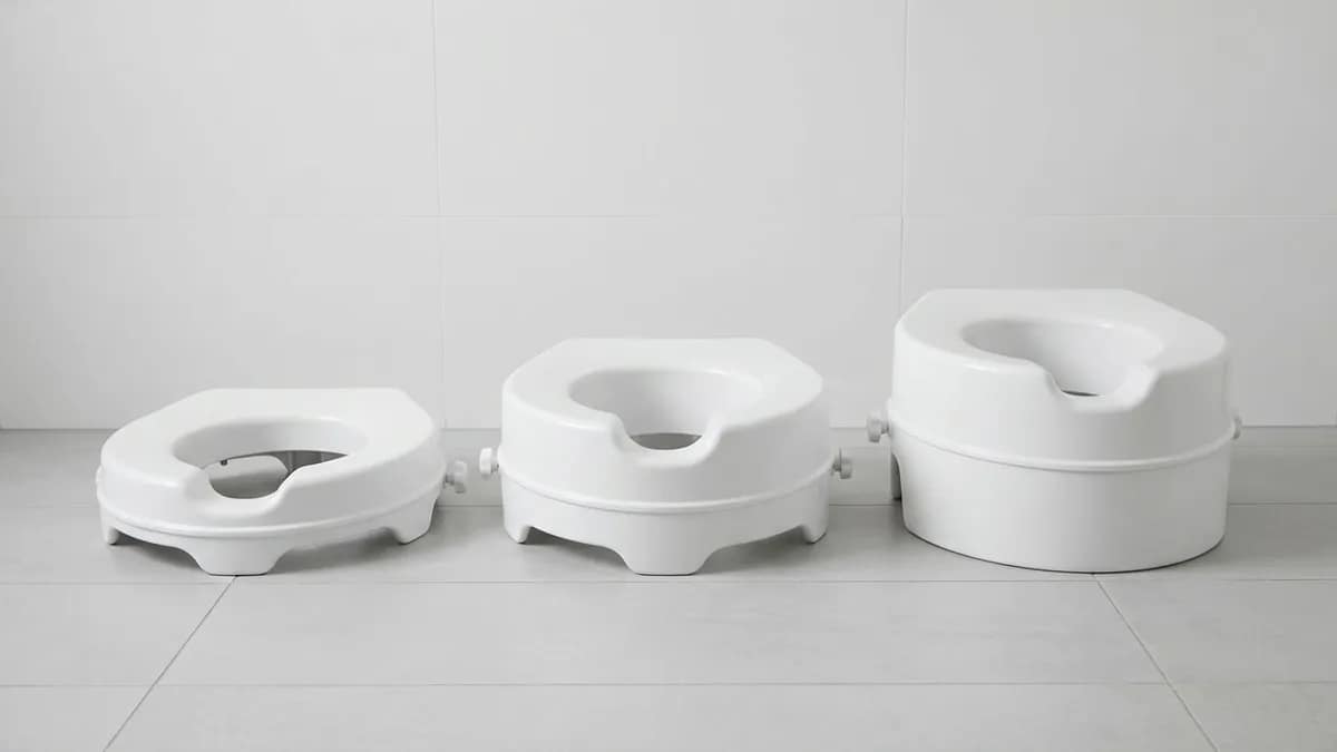 Three raised toilet seats of different heights placed side by side, showing low, medium, and high height options for comparison