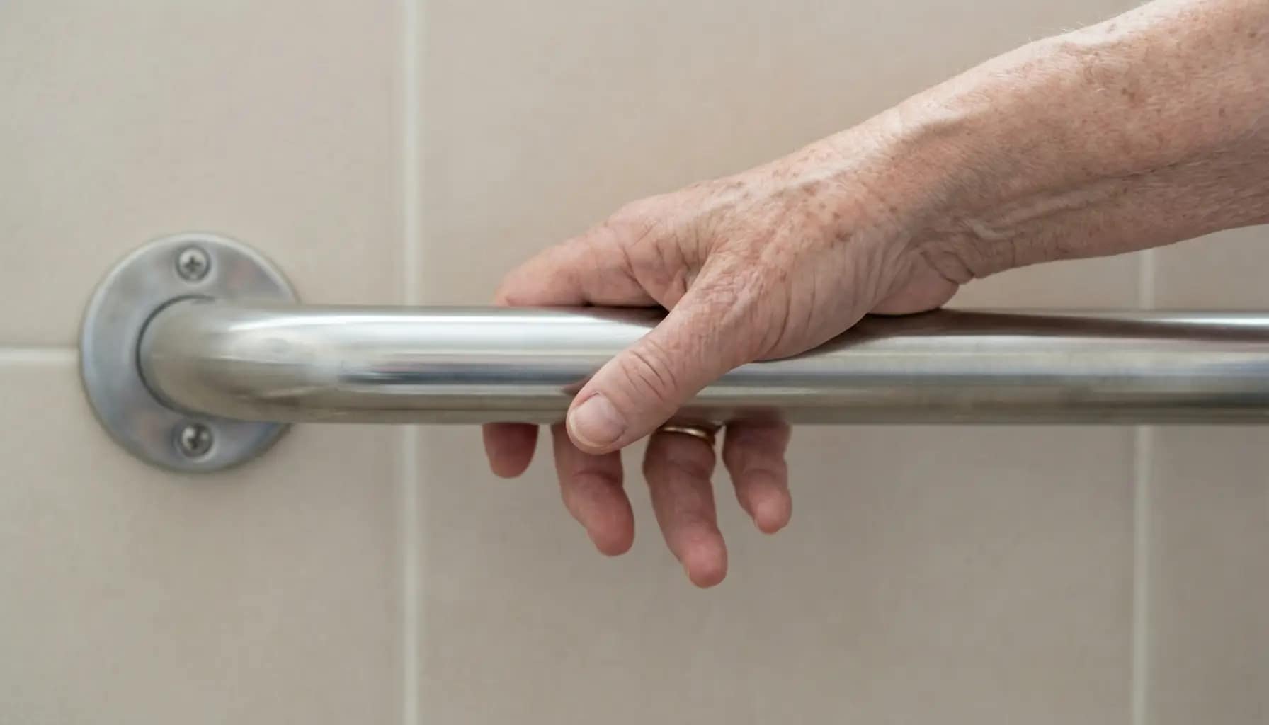 hand loosely holding a smooth grab bar showing reduced grip strength