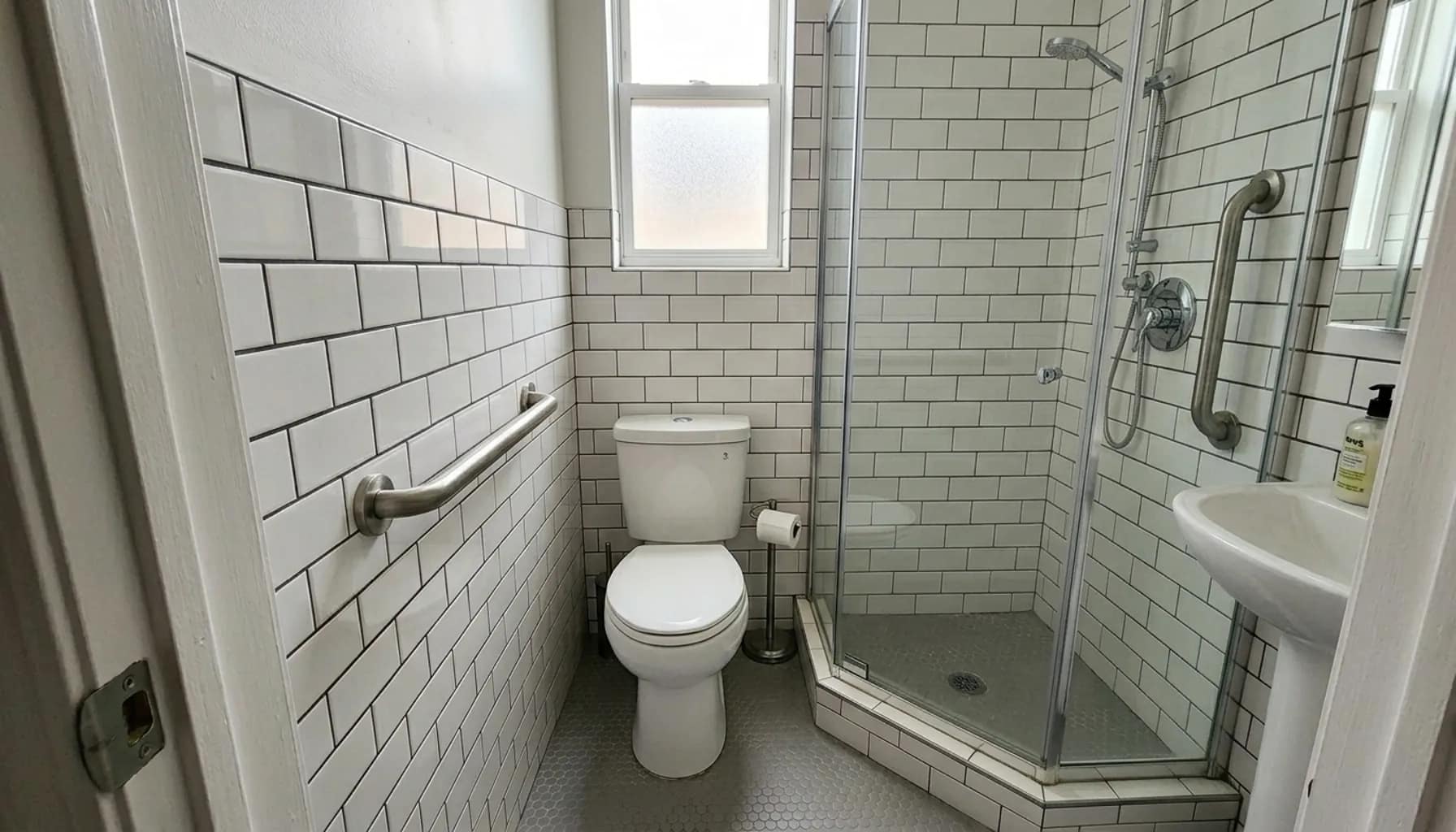 grab bars for small bathrooms installed in compact layout near toilet and shower