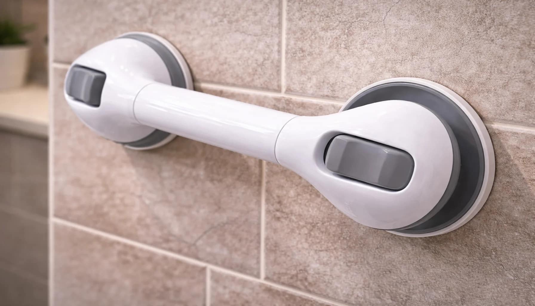 suction grab bar partially detaching from textured bathroom tile wall showing unsafe installation surface