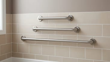 three different grab bar lengths installed on a bathroom wall for size comparison