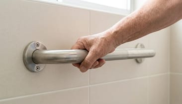 hand gripping a textured bathroom grab bar showing secure and comfortable hold